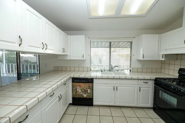 a kitchen with a sink stove and cabinets