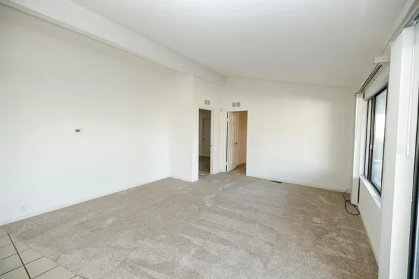 a view of an empty room and a window