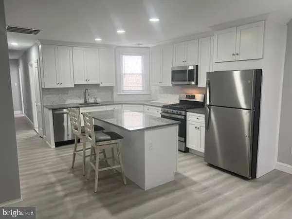 a kitchen with wooden cabinets and stainless steel appliances