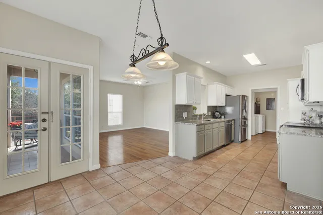 a kitchen with kitchen island granite countertop a stove sink and refrigerator