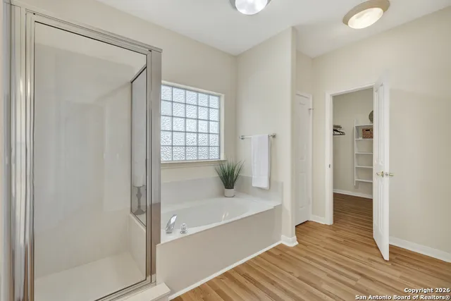 a view of a closet with wooden floor