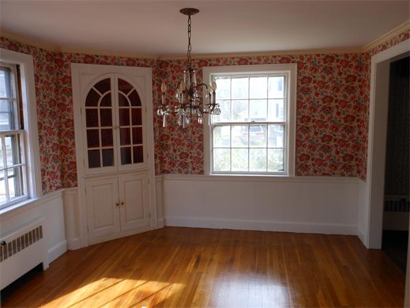 57 Buckingham Road Milton, MA 02186 - Photo 4 of 9 a view of a livingroom with wooden floor and windows