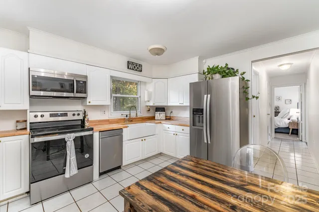 a kitchen with a stove a sink and a refrigerator