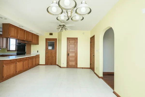 a view of staircase with wooden floor and white walls