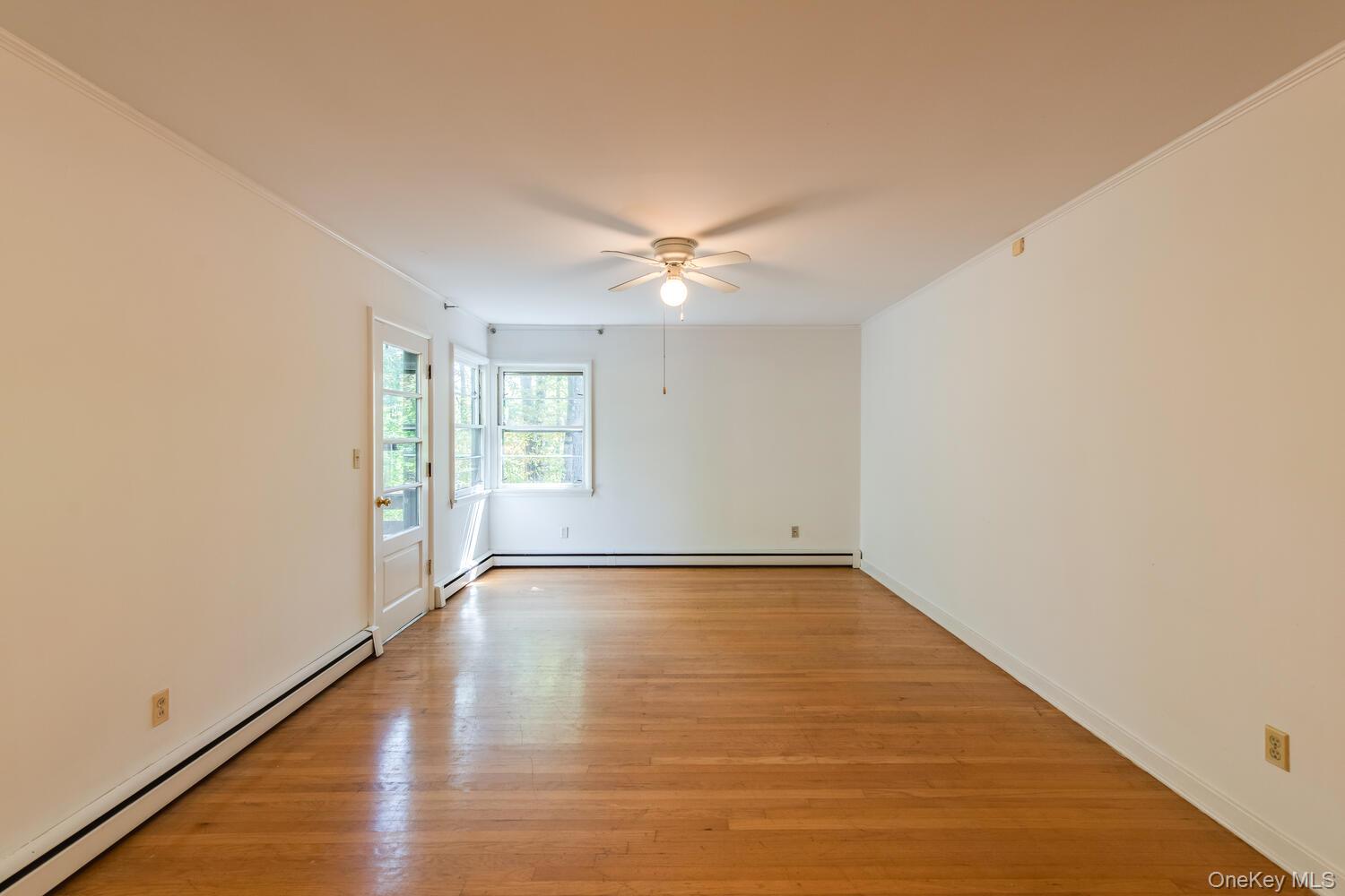 19 Ridgeview Road Poughkeepsie, NY 12603 - Photo 26 of 50 a view of an empty room with window and wooden floor