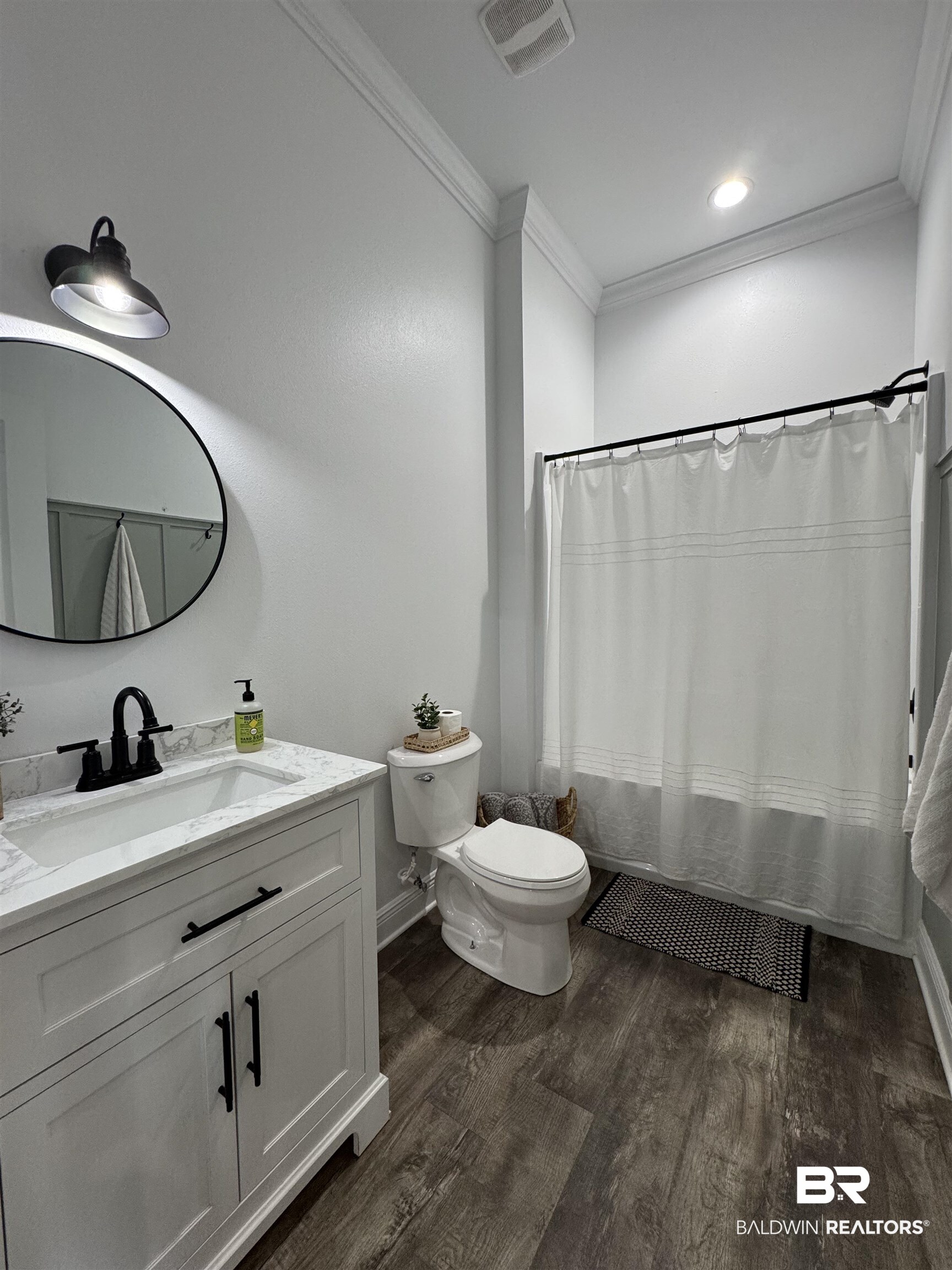 370 Dianne Road Frisco City, AL 36445 - Photo 22 of 41 Full bathroom with hardwood / wood-style floors, vanity, toilet, and ornamental molding