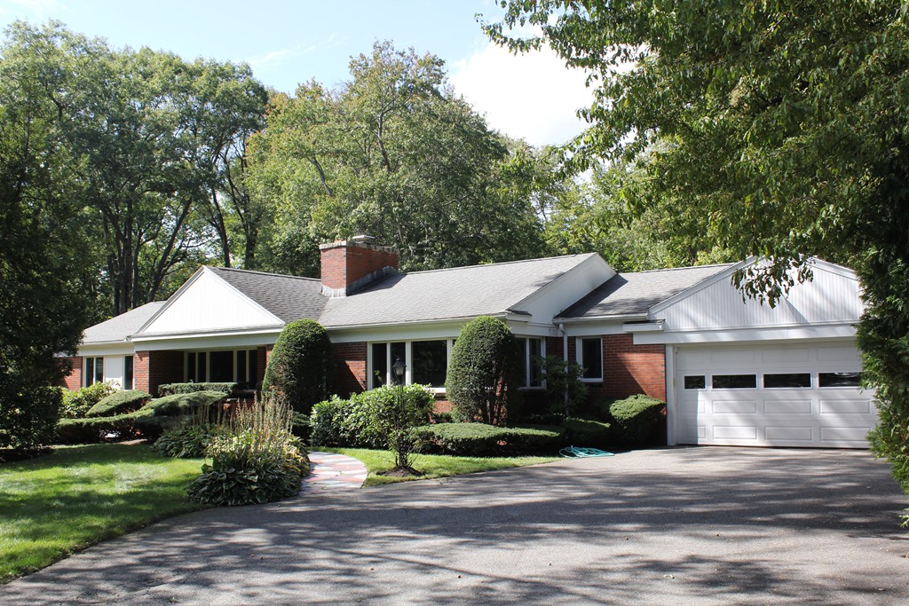 a front view of a house with a garden