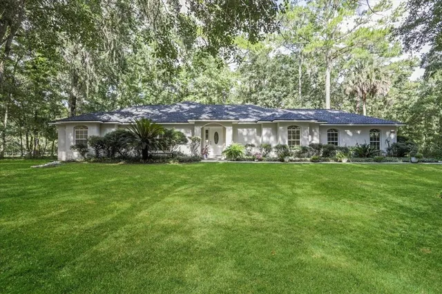 a front view of house with yard and green space