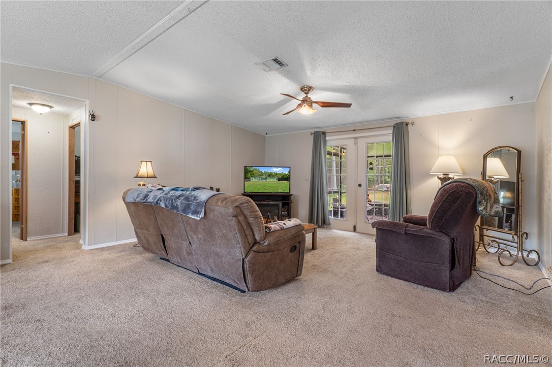 7927 West Cyprian Court Homosassa, FL 34448 - Photo 30 of 40 a living room with furniture and a chandelier