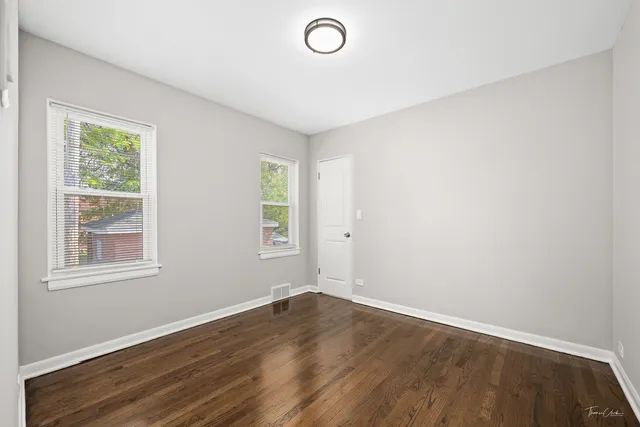 a large bed sitting in a bedroom next to a window