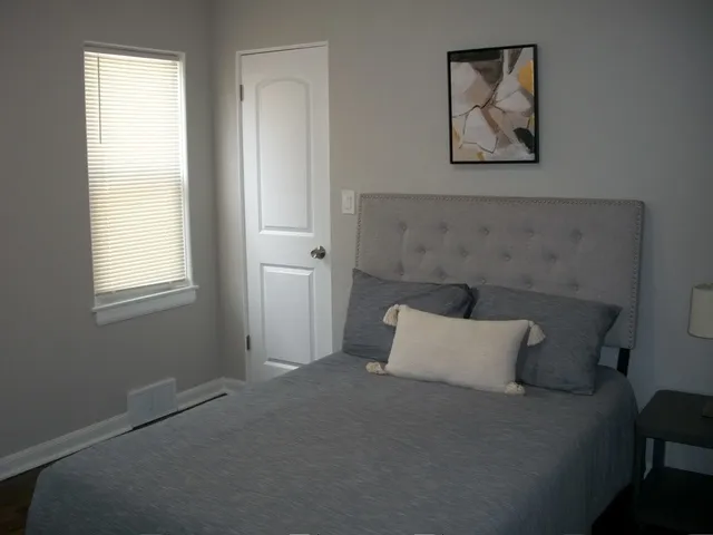 a bedroom with a bed and cabinets