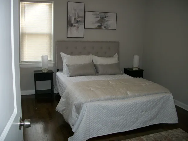 a bedroom with a bed and a window