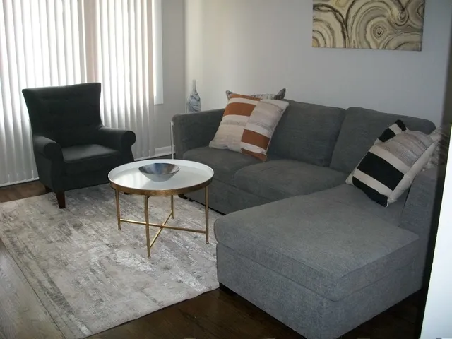 a kitchen with granite countertop a stove a sink and dishwasher with white cabinets
