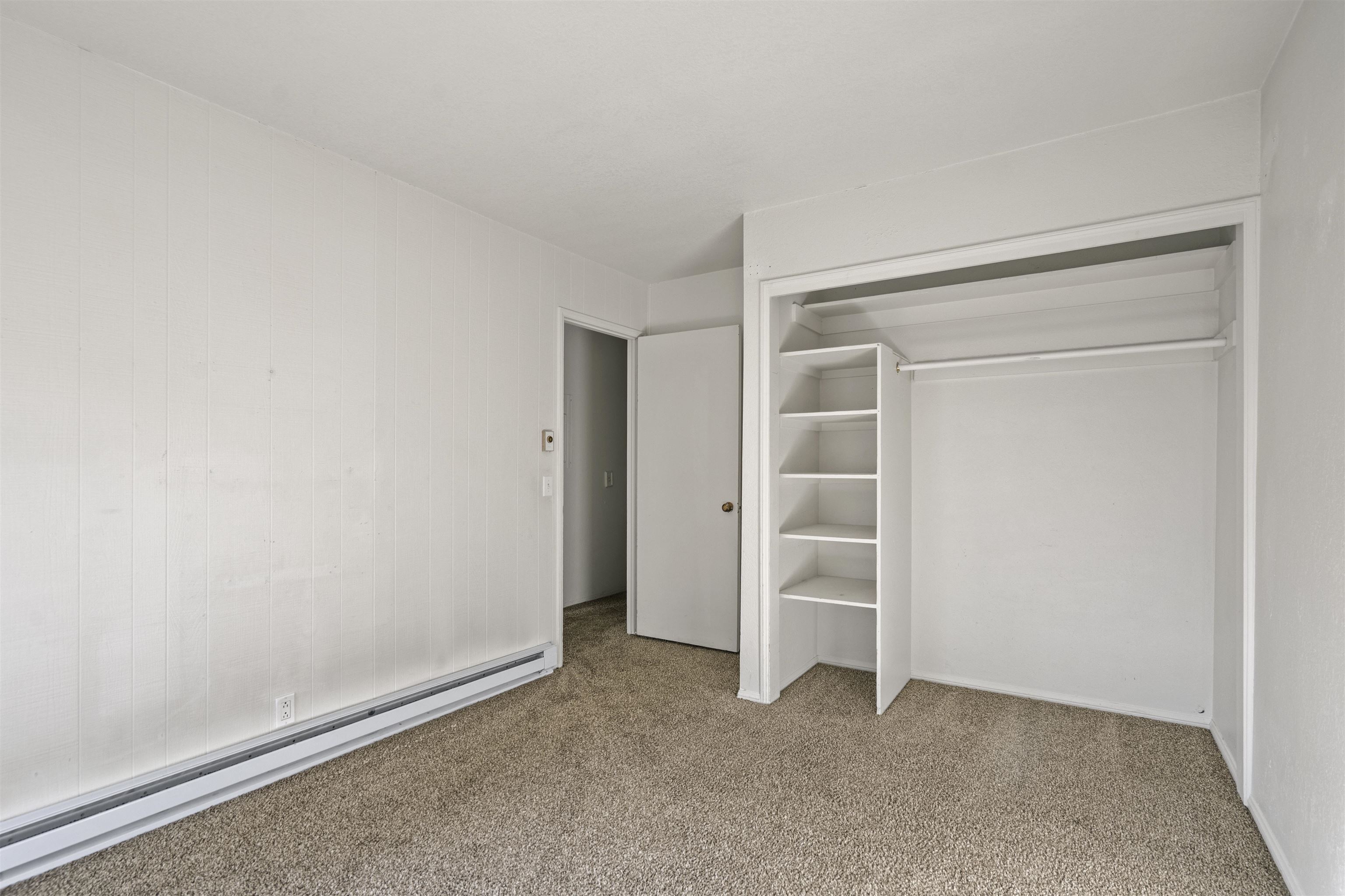 3199 Chateau Road, Unit 18 Mammoth Lakes, CA 93546 - Photo 15 of 19 Unfurnished bedroom with a baseboard radiator, light carpet, and a closet