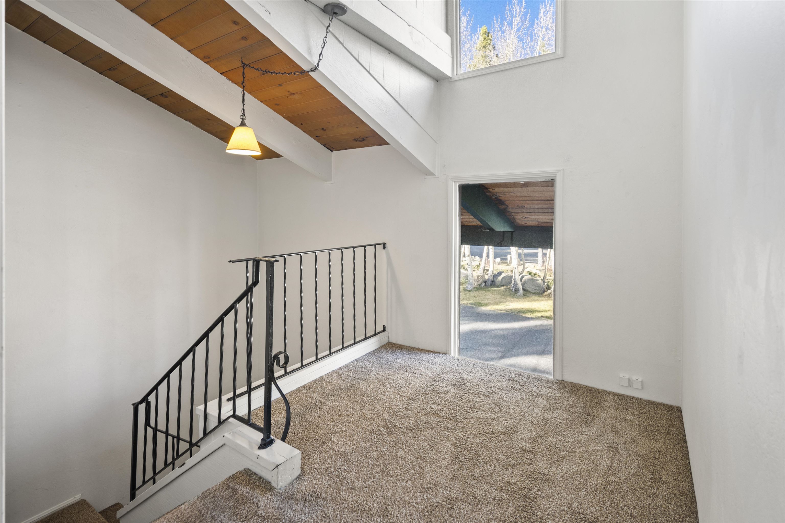 3199 Chateau Road, Unit 18 Mammoth Lakes, CA 93546 - Photo 8 of 19 Stairway featuring carpet, a towering ceiling, and wood ceiling