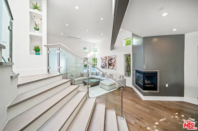 a living room with furniture window and wooden floor