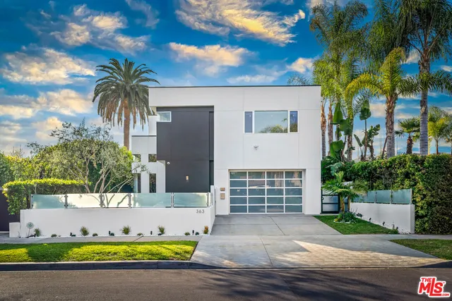 a view of a house with swimming pool and sitting area