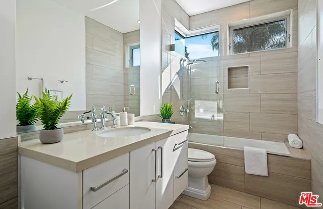 a bedroom with a large bed and a painting on the wall