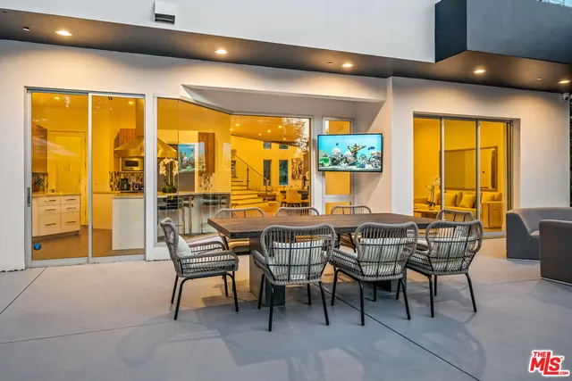a view of a house with swimming pool and sitting area