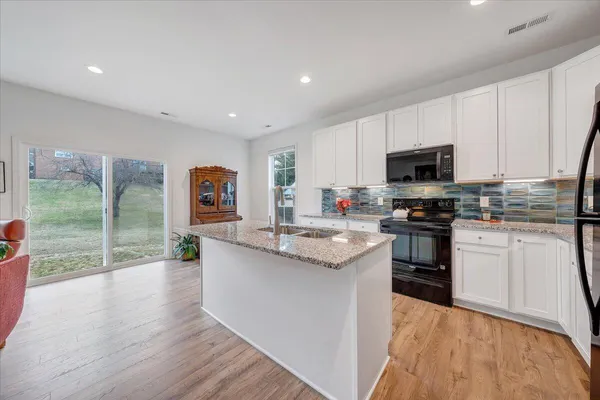 a view of kitchen sink with microwave and furniture