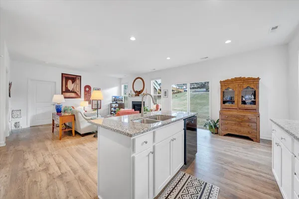a kitchen with granite countertop lots of clutter and stainless steel appliances