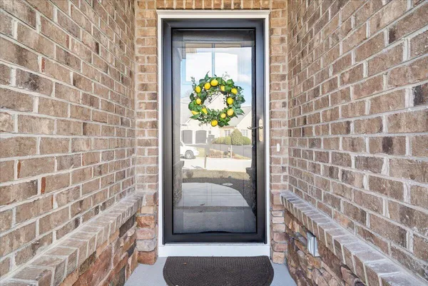 a view of a room with wooden floor lounge chair and windows
