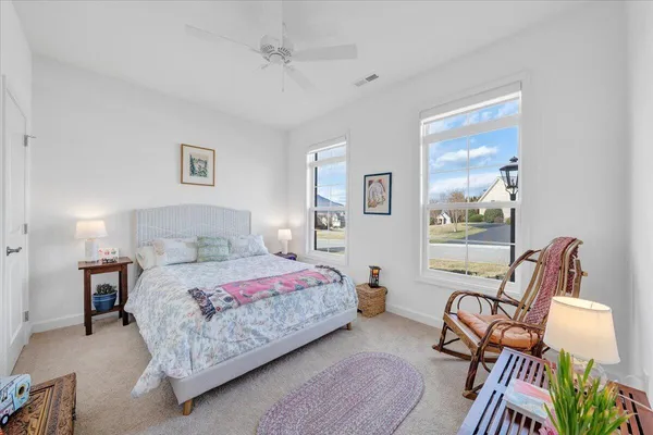 a bedroom that has a bed and chair