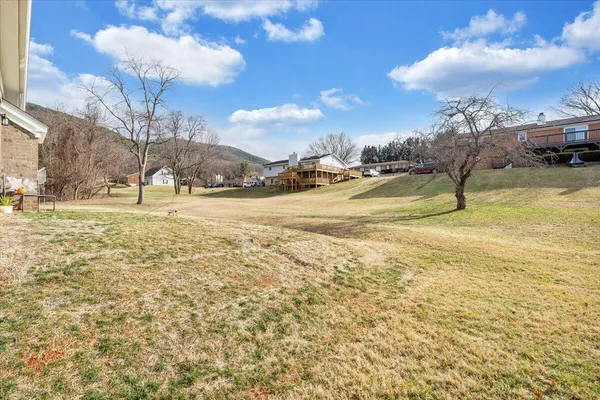 a front view of a house with a yard covered with snow and yard