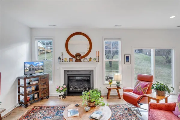 a living room with furniture kitchen view and a fireplace