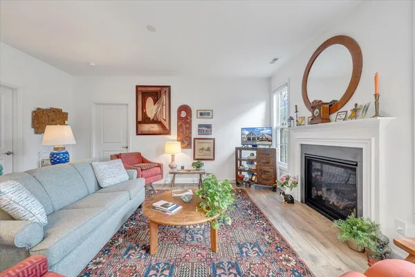 a kitchen with granite countertop a stove top oven a sink dishwasher a dining table and chairs with wooden floor