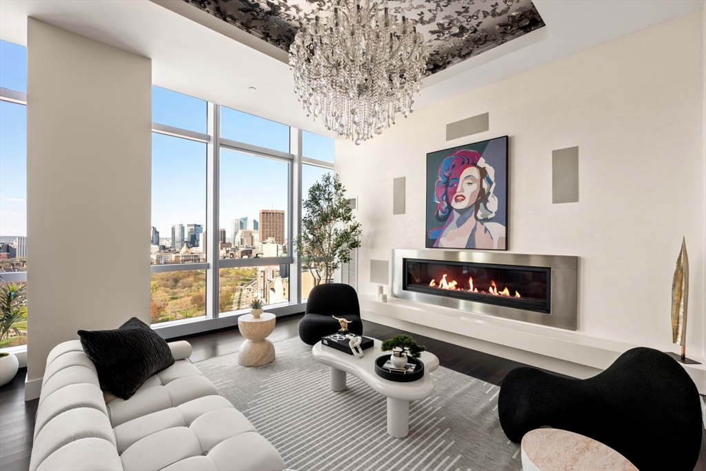 110 Stuart Street, Unit PH Boston, MA 02116 - Photo 2 of 37 a living room with furniture a fireplace and a large window