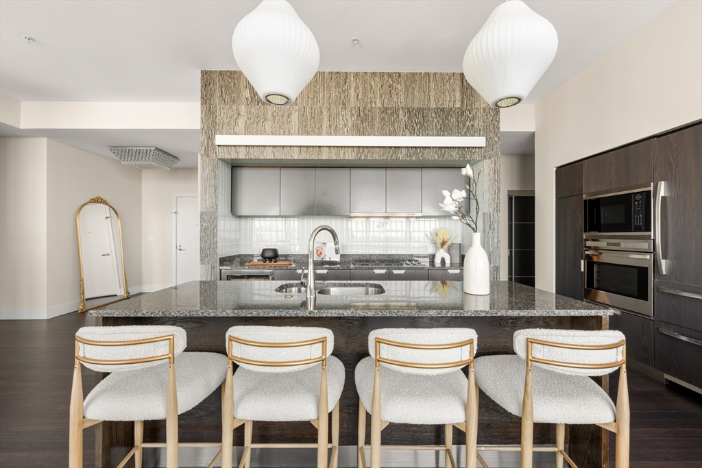 110 Stuart Street, Unit PH Boston, MA 02116 - Photo 10 of 37 a kitchen with a dining table and chairs