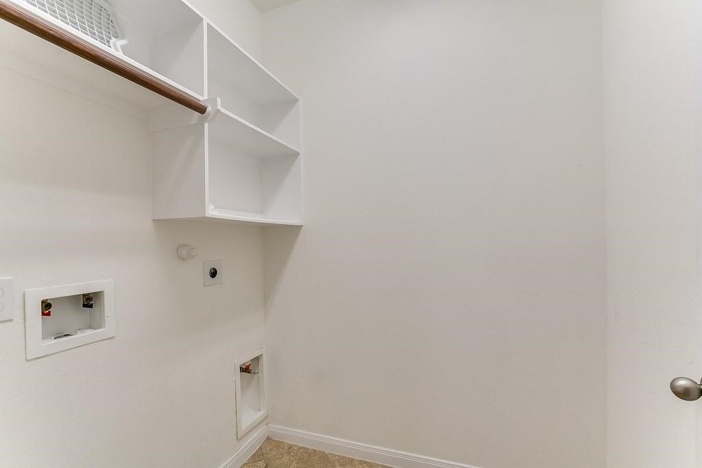 5803 Cedar Field Way Houston, TX 77084 - Photo 12 of 14 a view of small space with racks on the wall