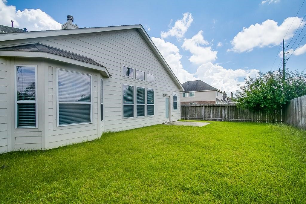 5803 Cedar Field Way Houston, TX 77084 - Photo 13 of 14 a view of a house with a backyard