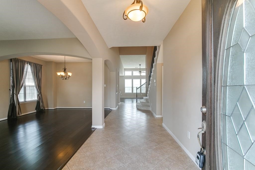 5803 Cedar Field Way Houston, TX 77084 - Photo 2 of 14 a view of a hallway view with wooden floor and staircase