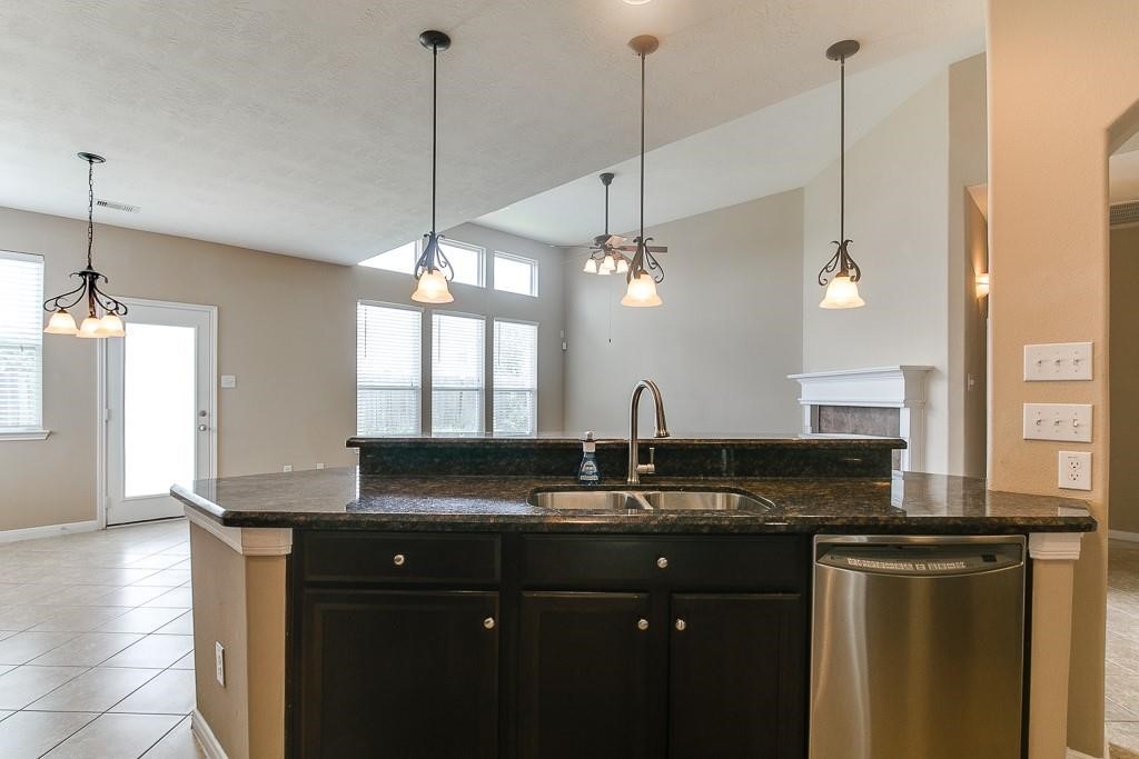 5803 Cedar Field Way Houston, TX 77084 - Photo 6 of 14 a kitchen with granite countertop a sink a counter top space and cabinets
