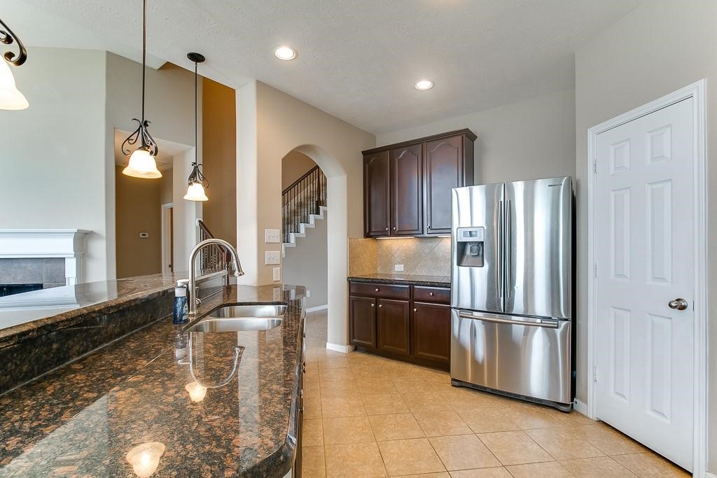 5803 Cedar Field Way Houston, TX 77084 - Photo 7 of 14 a kitchen with stainless steel appliances granite countertop a refrigerator and a sink