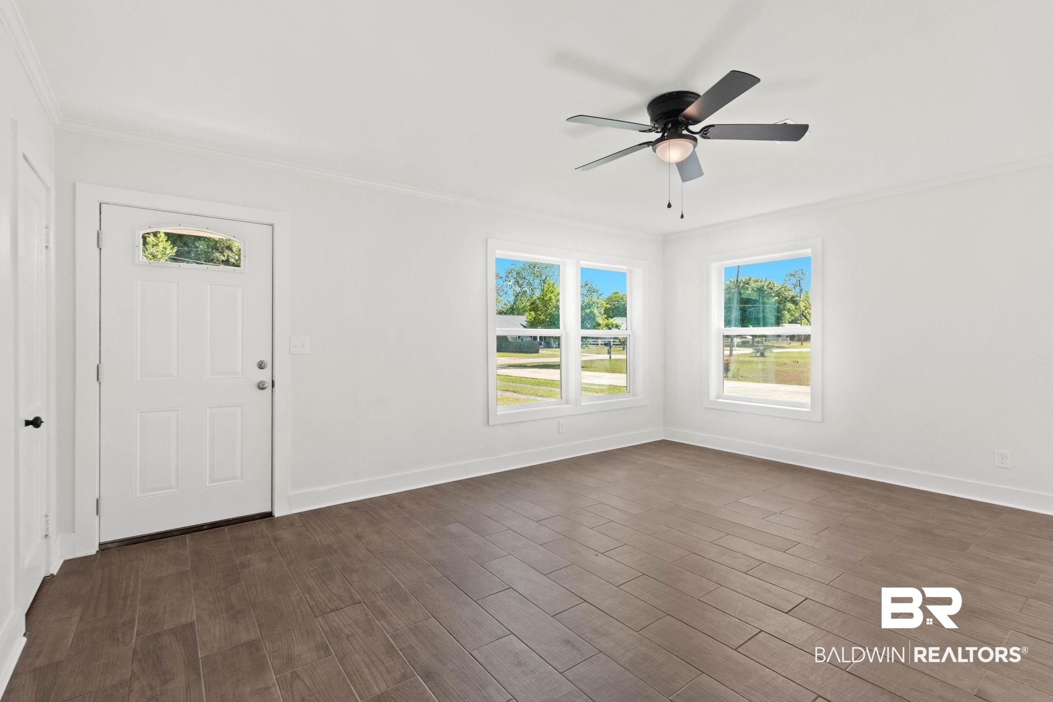 311 Cloverdale Road Atmore, AL 36502 - Photo 11 of 63 Open concept room featuring wood-finish flooring and a ceiling fan