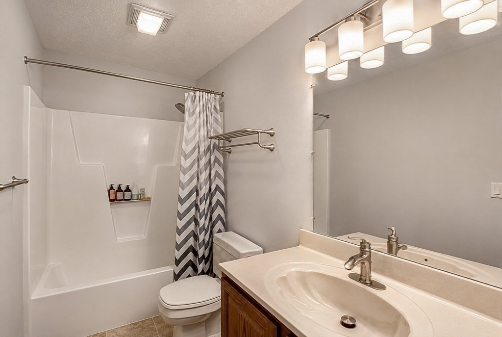 53 Century Way, Unit 53 Gardner, MA 01440 - Photo 17 of 22 a bathroom with a sink toilet and shower