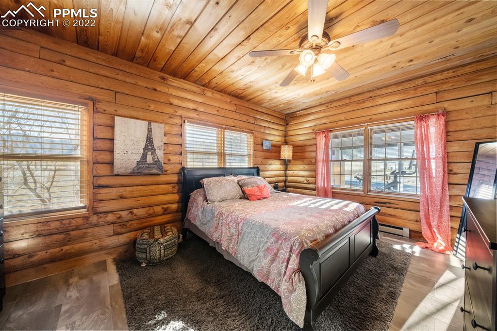 3645 Doolittle Road Monument, CO 80132 - Photo 12 of 39 a bedroom with a bed and large windows