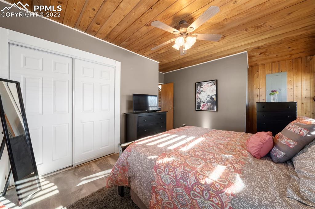 3645 Doolittle Road Monument, CO 80132 - Photo 13 of 39 a bedroom with a bed and a flat screen tv