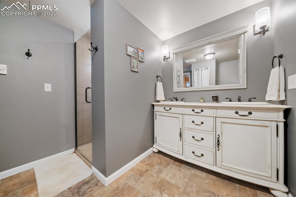 3645 Doolittle Road Monument, CO 80132 - Photo 18 of 39 a bathroom with a double vanity sink mirror and