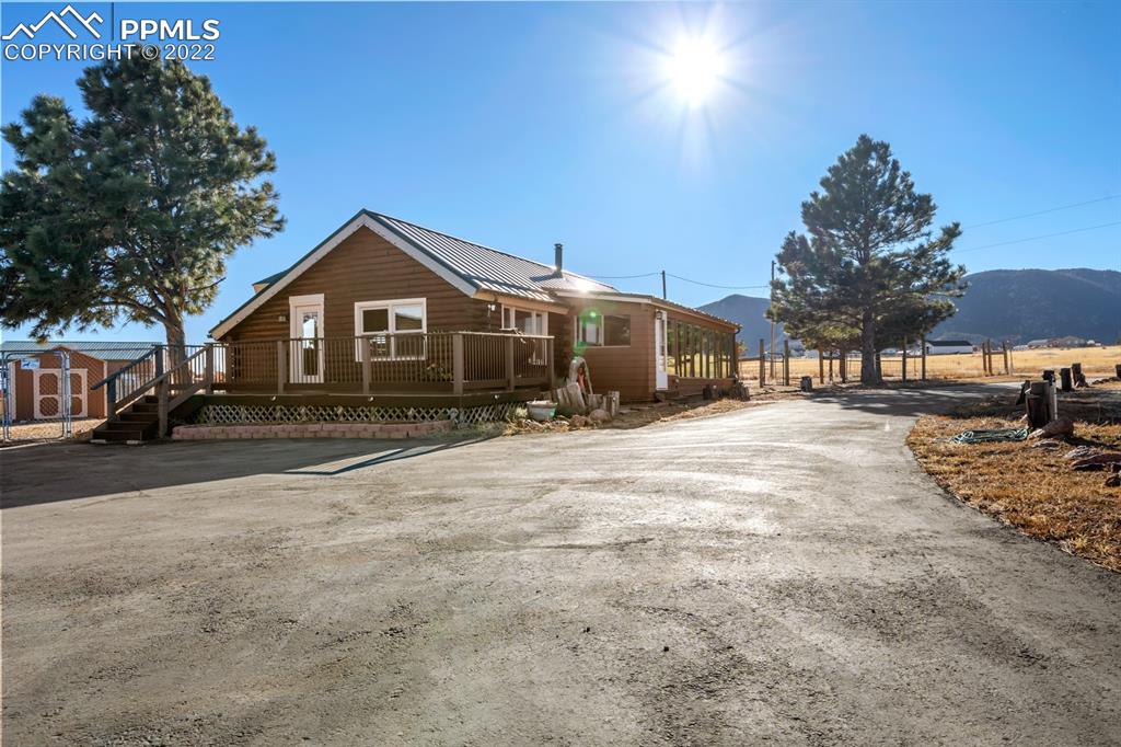 3645 Doolittle Road Monument, CO 80132 - Photo 2 of 39 a front view of a house with a yard and trees