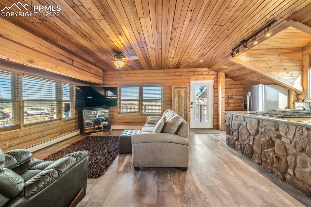 3645 Doolittle Road Monument, CO 80132 - Photo 8 of 39 a living room with furniture and a flat screen tv