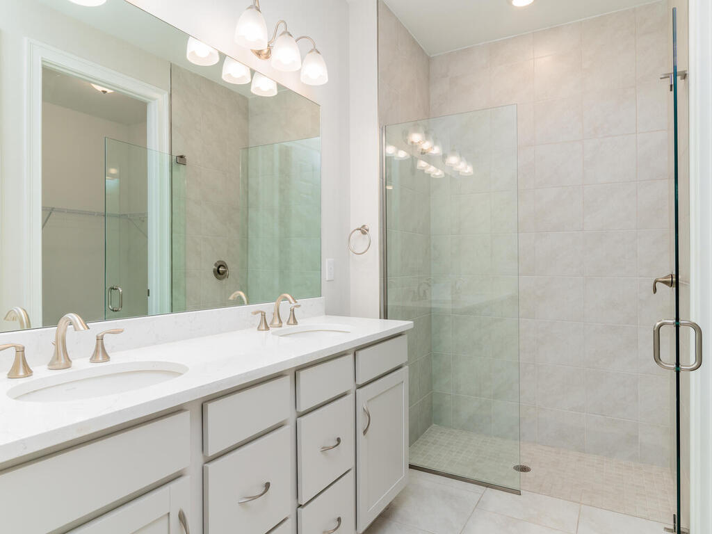 1176 Enbrook Loop Naples, FL 34114 - Photo 11 of 35 a bathroom with a double vanity sink mirror and shower