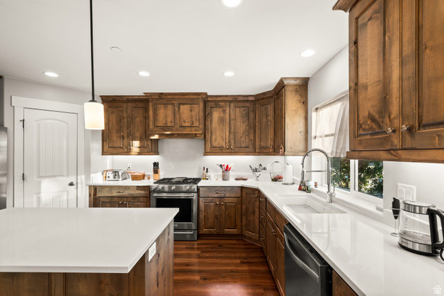 1145 North Christley Lane, Unit 48 Elk Ridge, UT 84651 - Photo 6 of 38 Spacious kitchen featuring extensive wood cabinetry, white countertops, stainless steel appliances, and wood-finish flooring