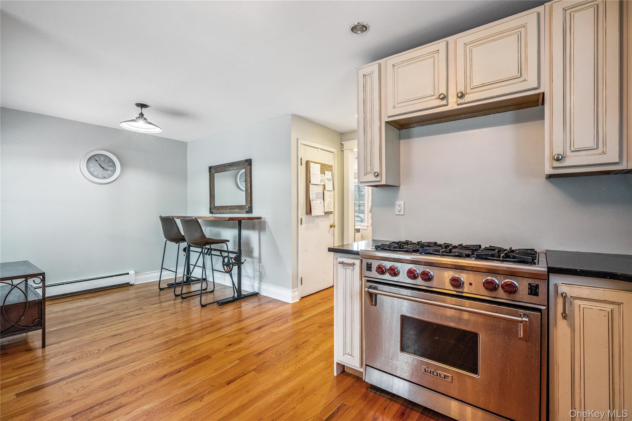 17 Tulip Road Rocky Point, NY 11778 - Photo 12 of 24 a kitchen with granite countertop wooden floor stainless steel appliances and cabinets