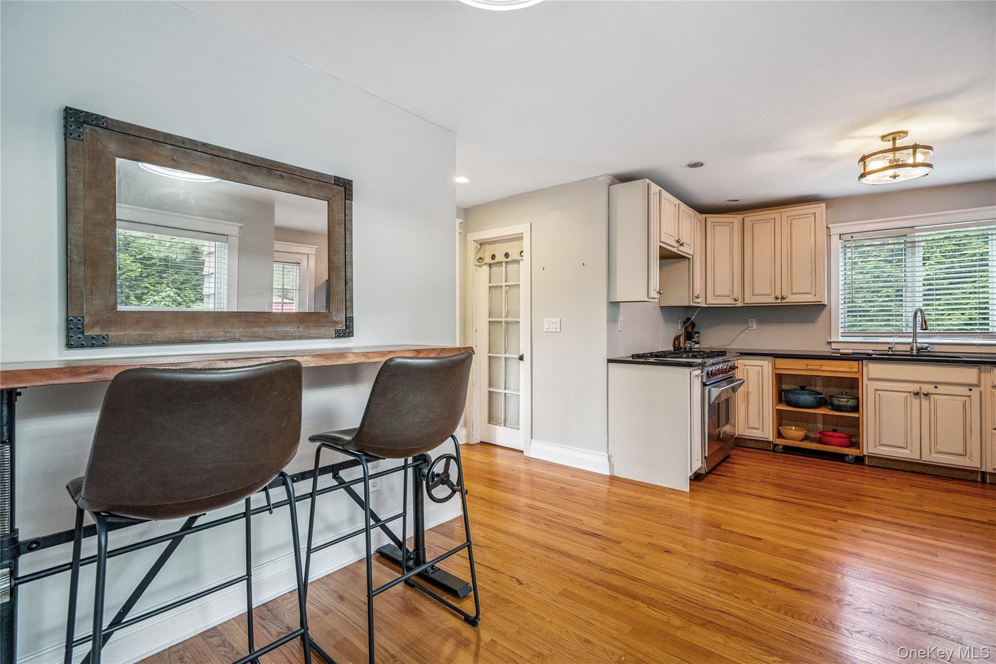 17 Tulip Road Rocky Point, NY 11778 - Photo 14 of 24 a kitchen with granite countertop wooden floors and white appliances