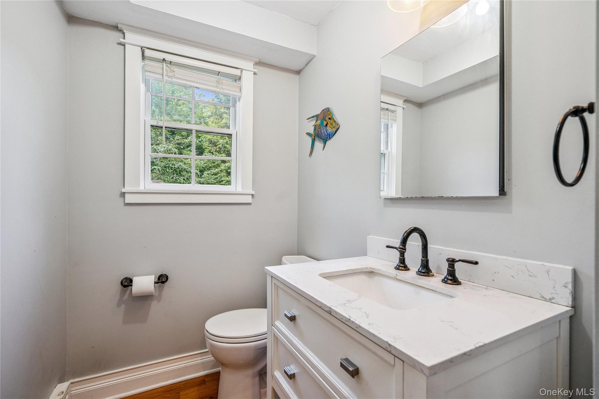 17 Tulip Road Rocky Point, NY 11778 - Photo 8 of 24 a bathroom with a sink toilet and a window