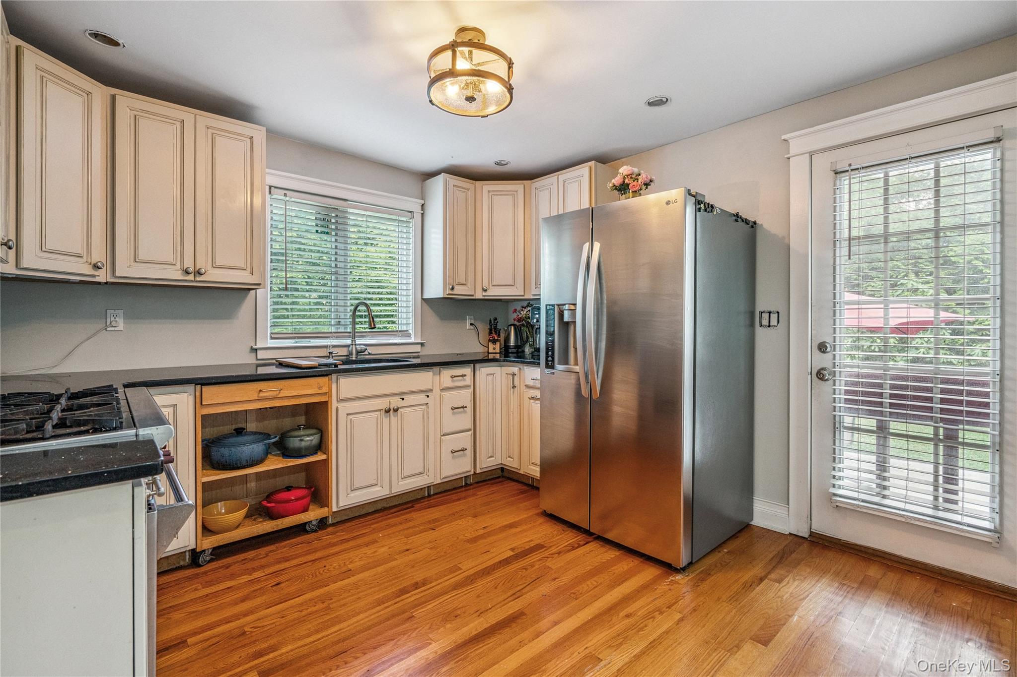 17 Tulip Road Rocky Point, NY 11778 - Photo 9 of 24 a kitchen with stainless steel appliances granite countertop a refrigerator a stove a sink and dishwasher with wooden floor